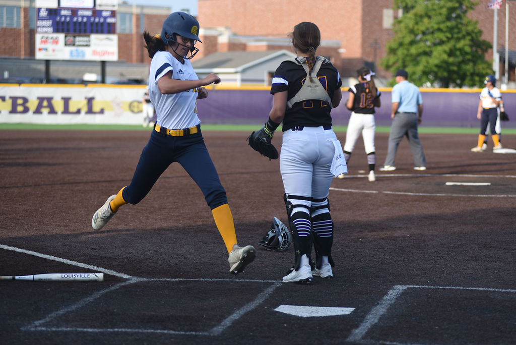 Kalea Baler runs into home base during the first inning in the Spartan's match against the Kewpies